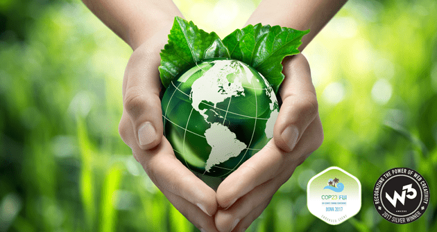 Hands holding a green Earth