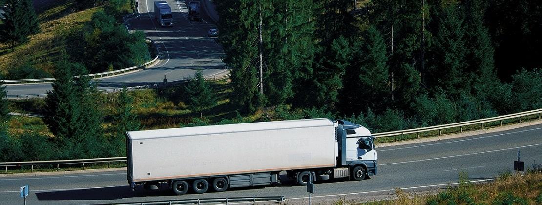 A freight truck moving by road