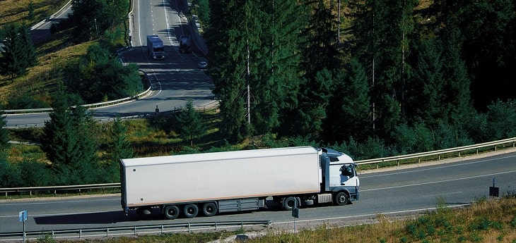 A freight truck moving by road