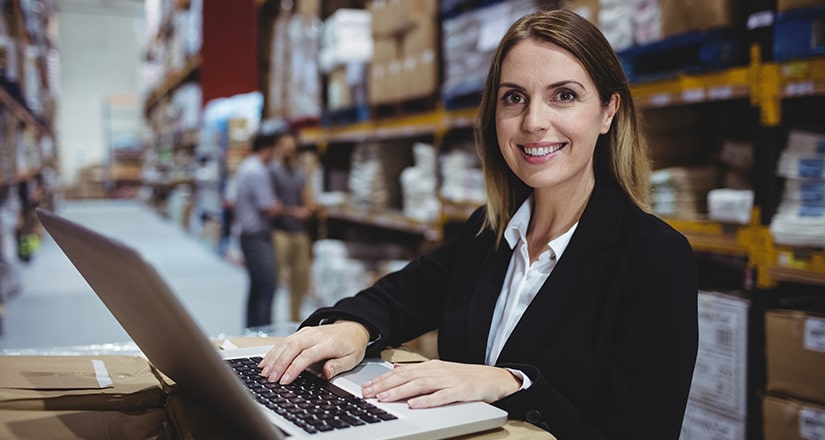 Woman smiling in front of a computer