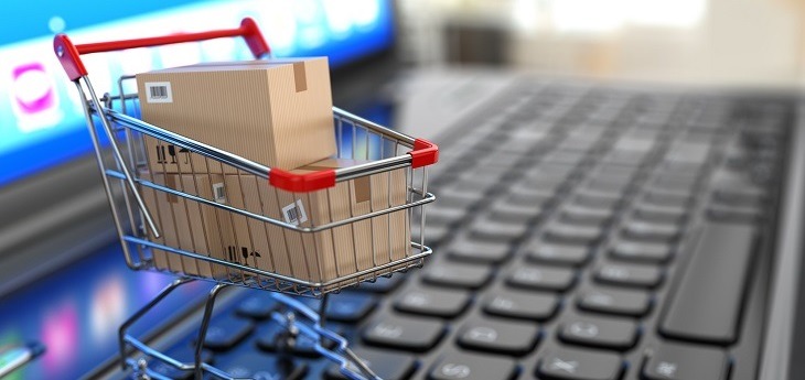 Shopping cart with cardboard boxes on a laptop.