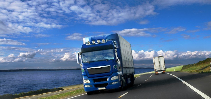 Blue freight truck moving on the road
