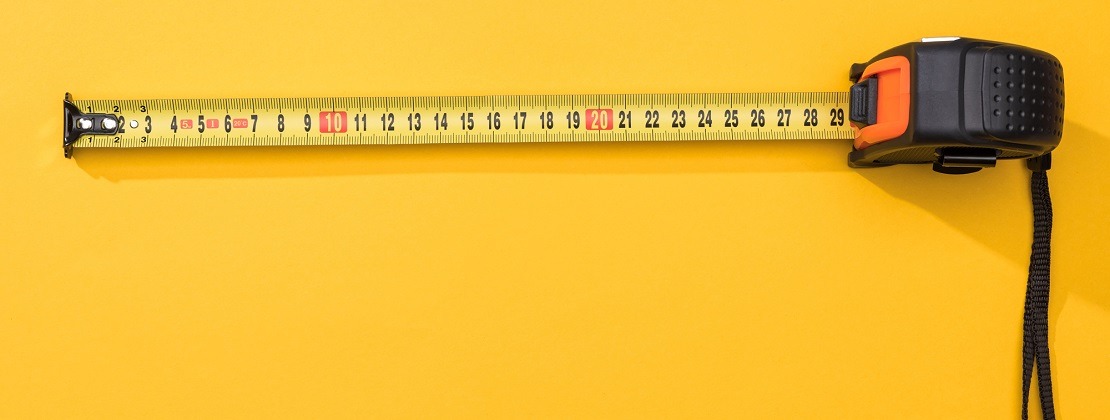 A measuring tape on a yellow background