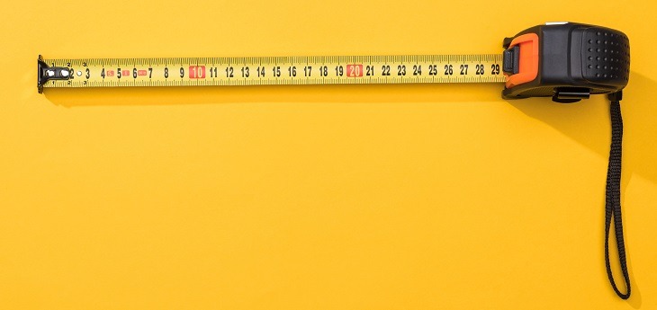 A measuring tape on a yellow background
