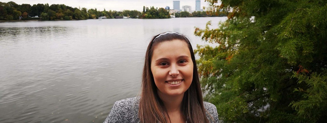 a Picture of Yelena Posing for a Picture in Front of a River