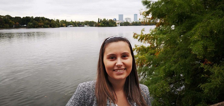 a Picture of Yelena Posing for a Picture in Front of a River