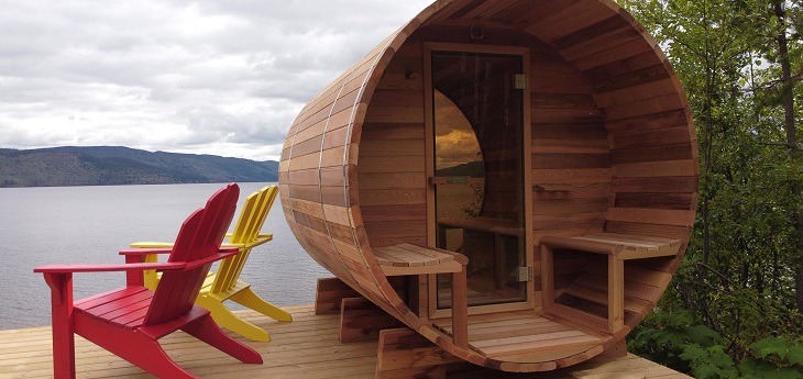 An outdoor hot tub on a pier next to a lake