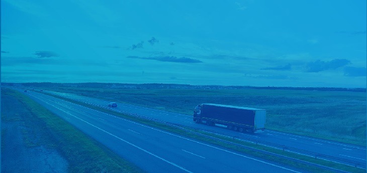 A freight truck moving by road