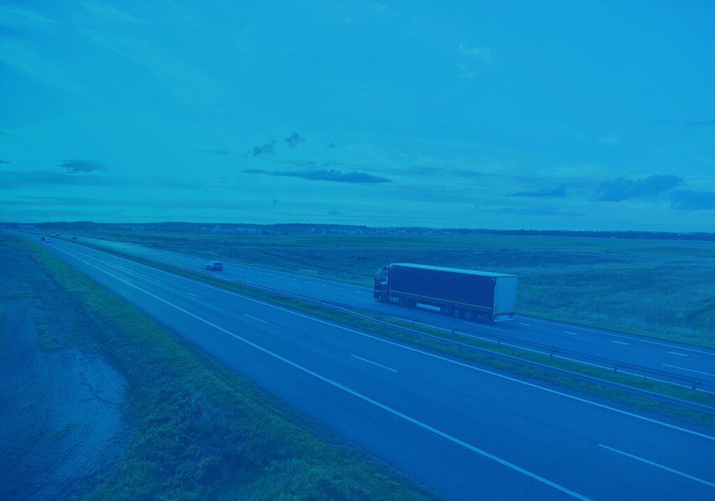 A freight truck moving by road