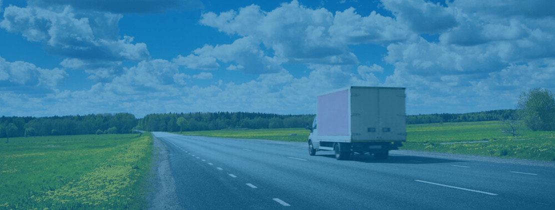 A straight freight truck moving by road.