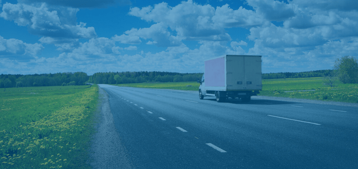 A straight freight truck moving by road.