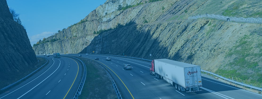 A freight truck moving by road