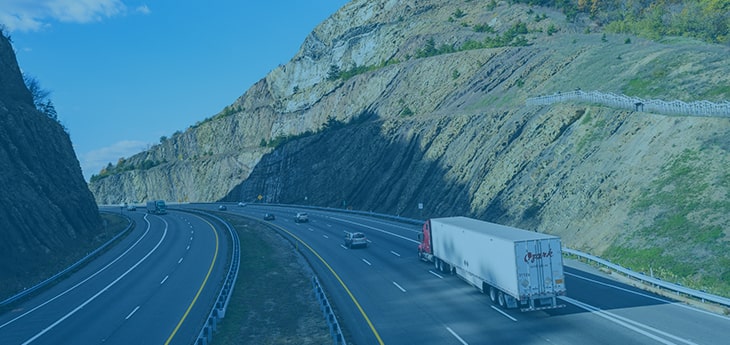 A freight truck moving by road