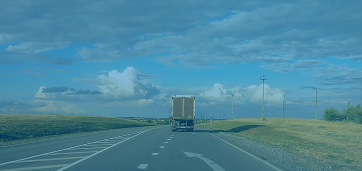 A freight truck driving off into the distance