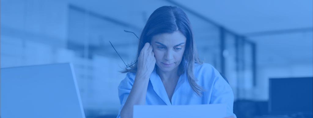 Businesswoman looking at a paper with a dismayed look