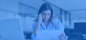 Businesswoman looking at a paper with a dismayed look