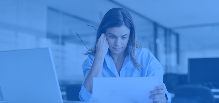 Businesswoman looking at a paper with a dismayed look