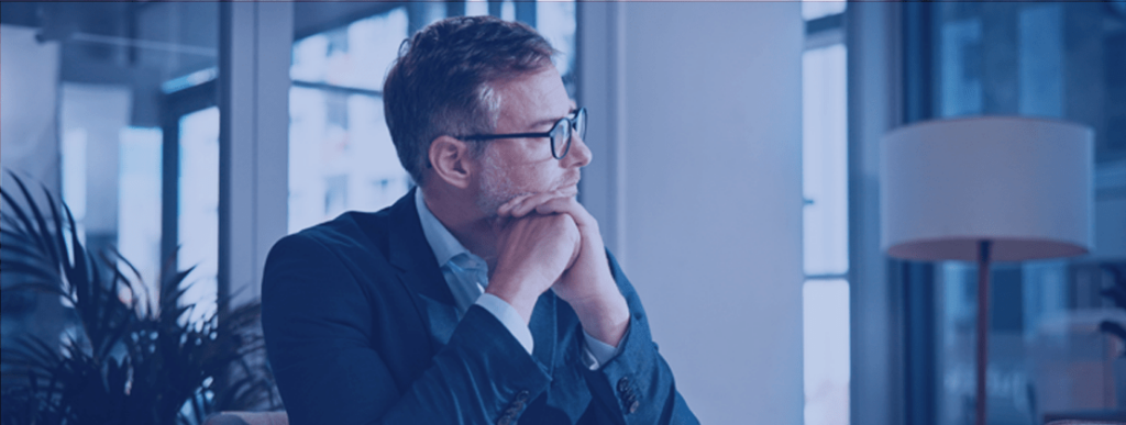 Businessman sitting at a desk, deep in thought