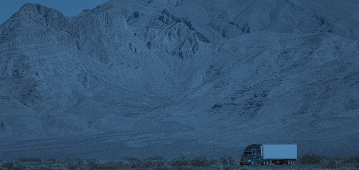 A freight truck moving across the Rocky Mountains.