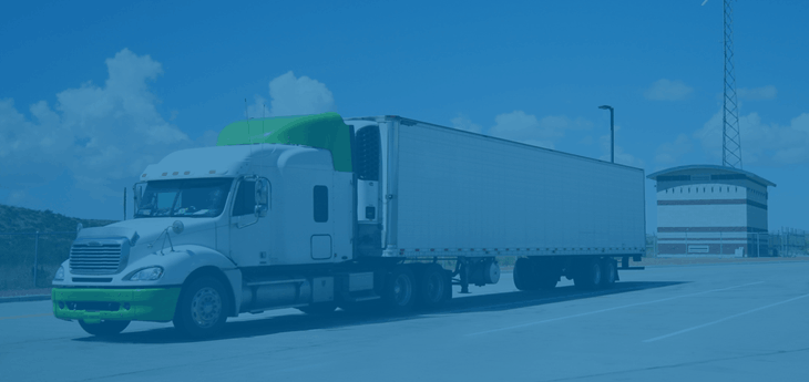 Freight truck parked at a rest stop.