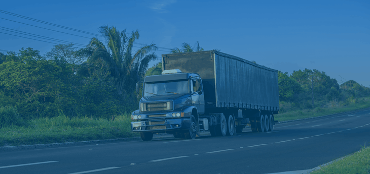 American-type truck riding on the road.