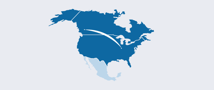 An illustration of a line crossing the USA-Canada border symbolizing cross border shipping