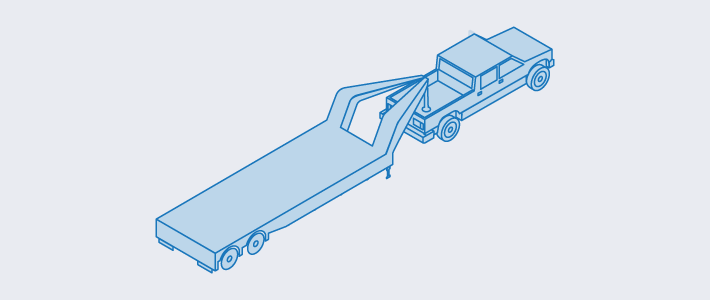 A gooseneck trailer attached to a pickup truck used in hot-shot shipping services